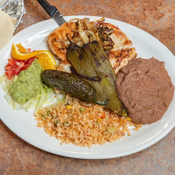 Grilled chicken with roasted peppers, rice, refried beans, guacamole, pico de gallo, and tortillas.